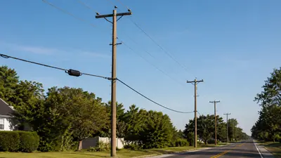 Tall distribution poles with high supply conductors and a separate lower fiber communications strand