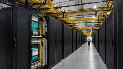High-density fiber distribution cabinets and overhead raceways in a large data center corridor